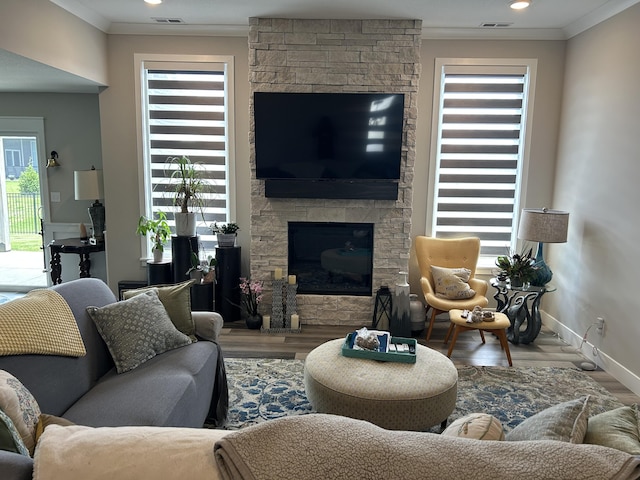 1001 Shore Acres Loop, Columbia, MO 65201 - living room with crown molding, a stone fireplace, wood finished floors, and baseboards