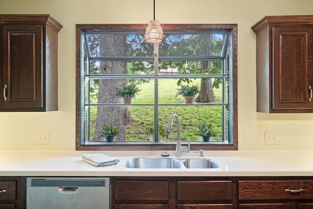 2036 Wendemere Ct, Jefferson City, MO 65109 - kitchen with stainless steel dishwasher, a sink, dark brown cabinets, and light countertops