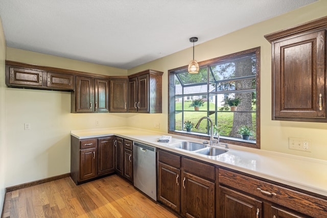 2036 Wendemere Ct, Jefferson City, MO 65109 - kitchen featuring stainless steel dishwasher, a sink, light wood-type flooring, dark brown cabinets, and light countertops
