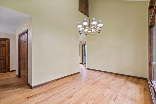 2036 Wendemere Ct, Jefferson City, MO 65109 - unfurnished dining area with a chandelier, light wood-style floors, and baseboards