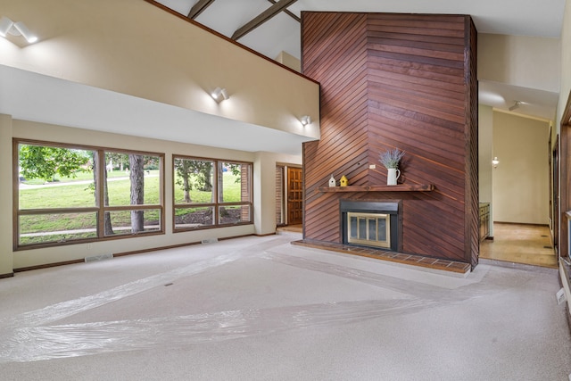 2036 Wendemere Ct, Jefferson City, MO 65109 - unfurnished living room with a high ceiling, a fireplace, and carpet floors