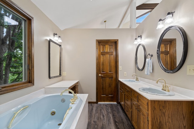 2036 Wendemere Ct, Jefferson City, MO 65109 - bathroom featuring vaulted ceiling, plenty of natural light, a whirlpool tub, wood finished floors, and double vanity