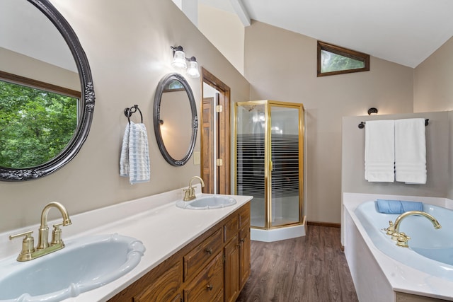 2036 Wendemere Ct, Jefferson City, MO 65109 - full bathroom featuring vaulted ceiling, a shower stall, a garden tub, double vanity, and wood finished floors