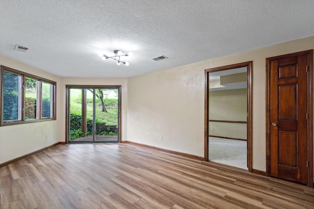 2036 Wendemere Ct, Jefferson City, MO 65109 - spare room with light wood-style flooring, baseboards, and a textured ceiling