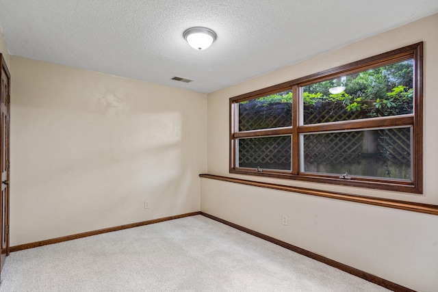 2036 Wendemere Ct, Jefferson City, MO 65109 - spare room featuring light colored carpet, a textured ceiling, and baseboards