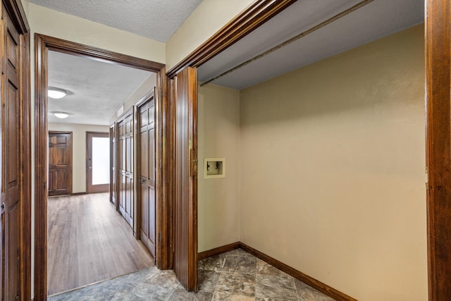 2036 Wendemere Ct, Jefferson City, MO 65109 - hallway featuring a textured ceiling and baseboards