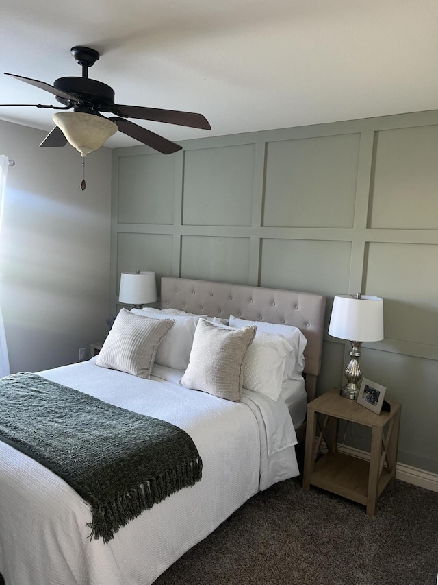 bedroom with a decorative wall, carpet flooring, and ceiling fan