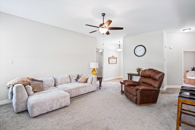 living room featuring carpet flooring, ceiling fan, and baseboards