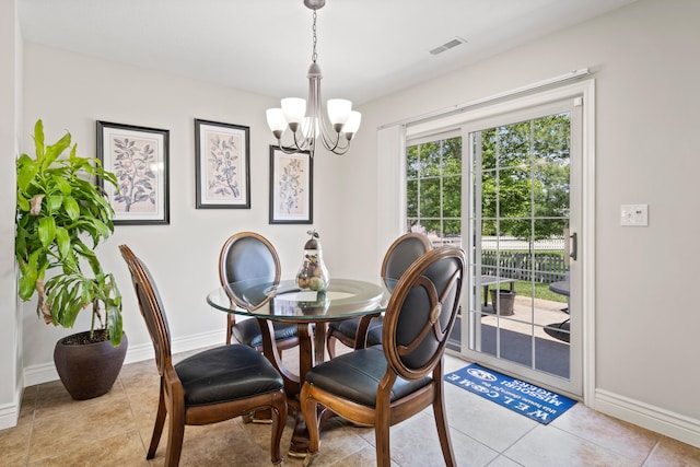 dining room featuring a chandelier, baseboards, and light tile patterned flooring