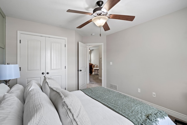 carpeted bedroom featuring baseboards, a closet, and ceiling fan