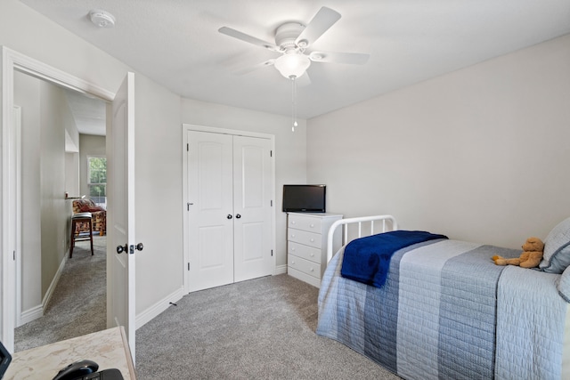 bedroom with carpet floors, a closet, a ceiling fan, and baseboards