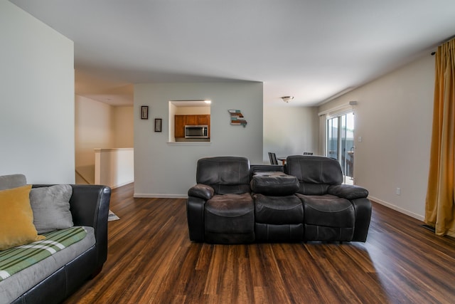 living area featuring wood finished floors and baseboards