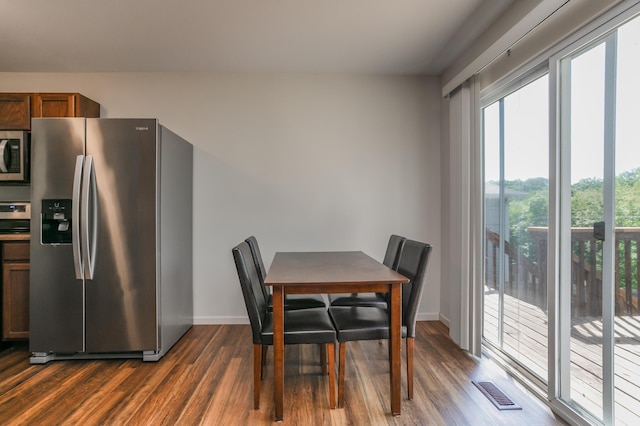 dining room with dark wood-style flooring and baseboards