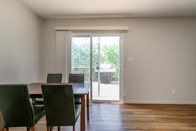 dining area featuring wood finished floors and baseboards