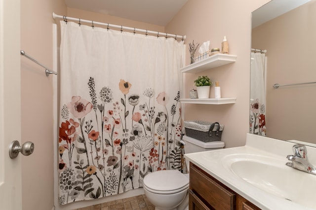 bathroom featuring vanity, toilet, and curtained shower