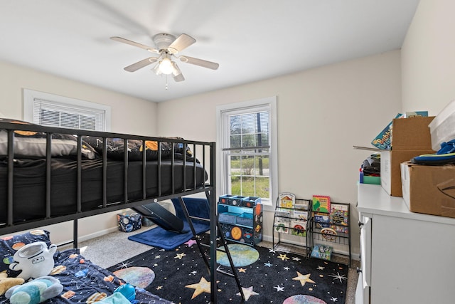 bedroom with baseboards, carpet flooring, and a ceiling fan