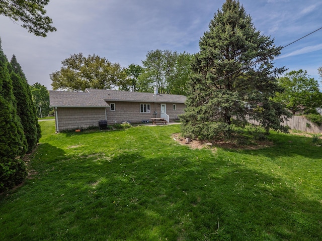 back of house with a lawn
