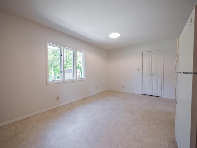 spare room featuring baseboards