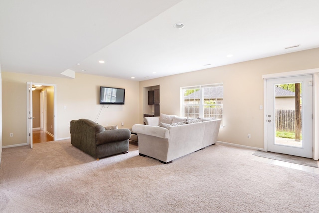 carpeted living area featuring baseboards and recessed lighting