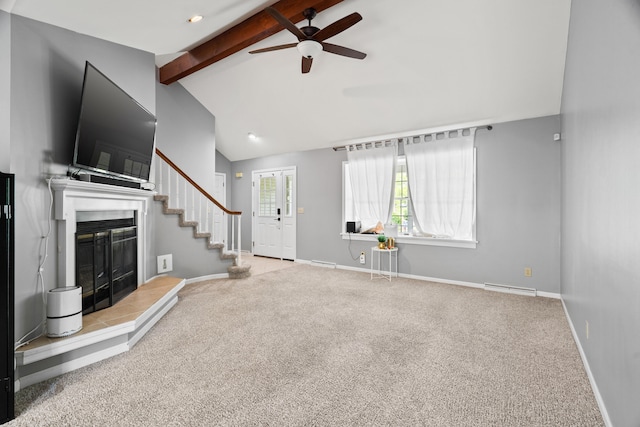 unfurnished living room with beamed ceiling, ceiling fan, carpet flooring, baseboards, and a fireplace