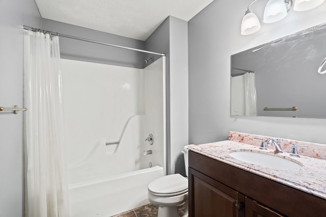 bathroom featuring toilet, vanity, shower / bath combo with shower curtain, and a textured ceiling