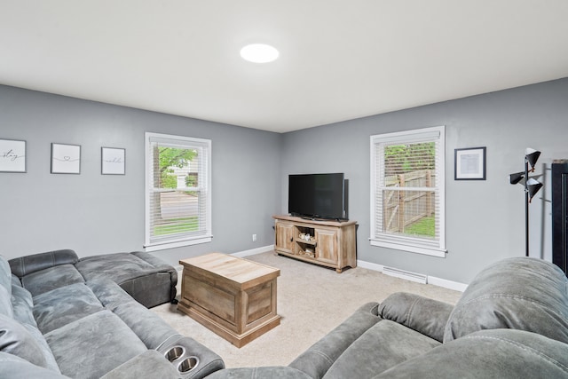 living room featuring light colored carpet, plenty of natural light, and baseboards