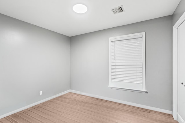 unfurnished room featuring light wood finished floors and baseboards