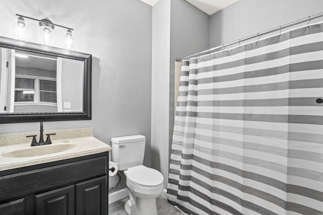 bathroom with toilet, vanity, and a shower with curtain