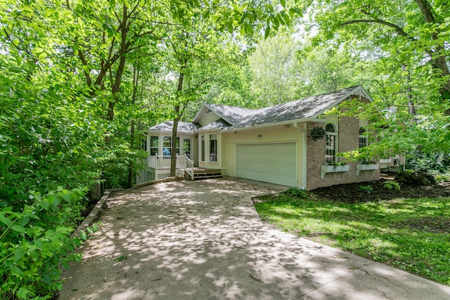 2105 Oak Point Ct, Columbia, MO 65203 - view of front of property featuring brick siding, an attached garage, concrete driveway, a shingled roof, and covered porch