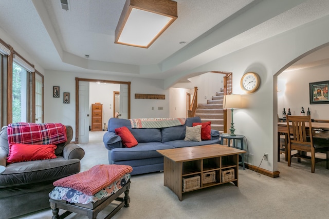 2105 Oak Point Ct, Columbia, MO 65203 - living room featuring arched walkways, stairway, and light carpet