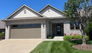view of front of house featuring an attached garage and concrete driveway