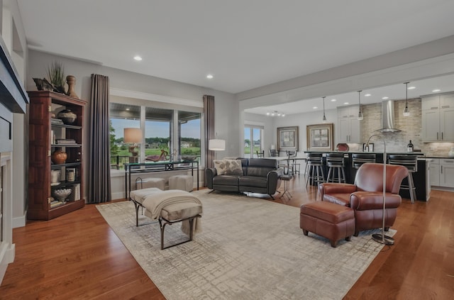 living area featuring wood finished floors and recessed lighting
