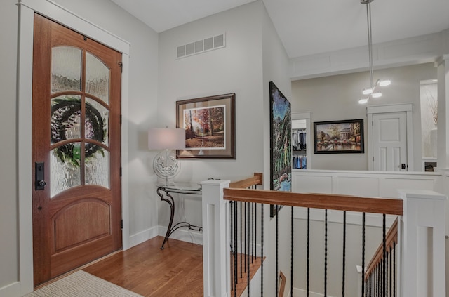 foyer entrance with wood finished floors and baseboards