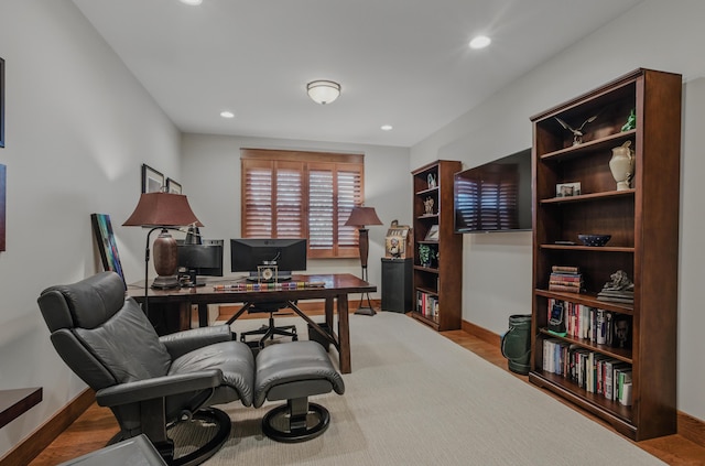 office area featuring baseboards, recessed lighting, and wood finished floors