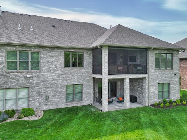 back of property featuring a patio area, a shingled roof, and a lawn