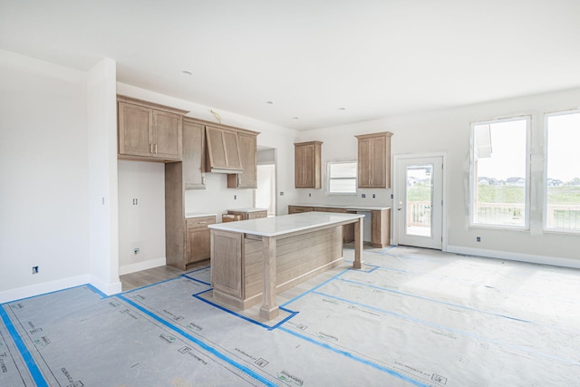 4725 Stayton Ferry Cir, Columbia, MO 65201 - kitchen featuring a kitchen island, baseboards, and brown cabinets