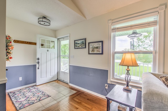 entryway featuring healthy amount of natural light, baseboards, and wood finished floors