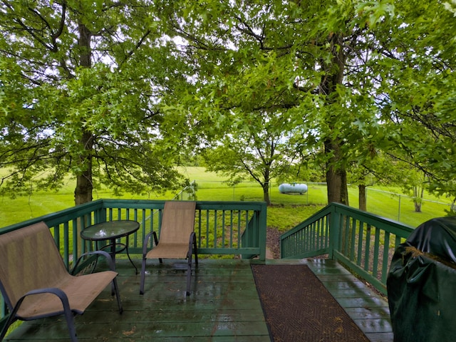 wooden deck featuring a lawn