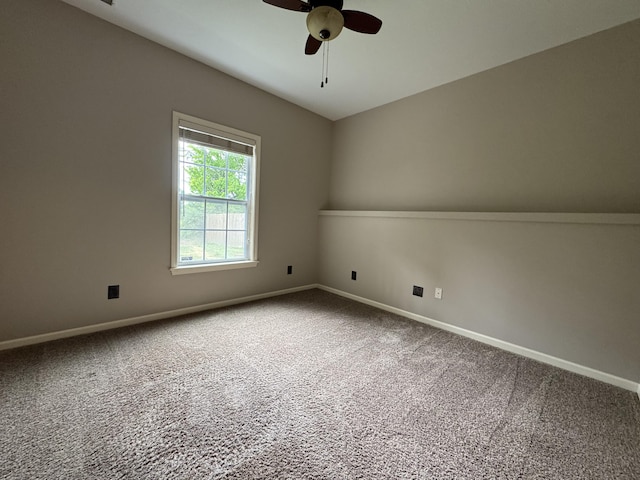 unfurnished room with carpet flooring, a ceiling fan, and baseboards