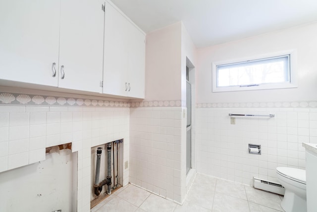 10155 E Union Church Rd, Centralia, MO 65240 - full bath with baseboard heating, tile walls, tile patterned floors, toilet, and a shower stall