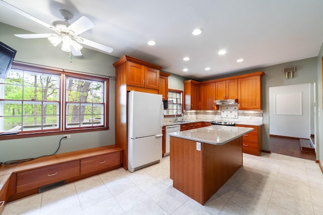 10155 E Union Church Rd, Centralia, MO 65240 - kitchen with white appliances, a sink, backsplash, brown cabinetry, and a ceiling fan