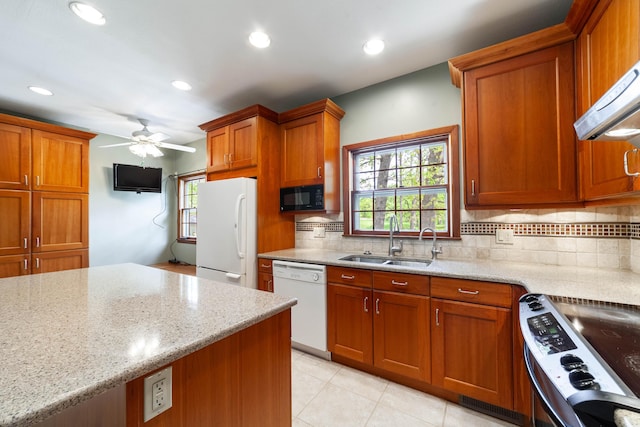 10155 E Union Church Rd, Centralia, MO 65240 - kitchen featuring a sink, white appliances, brown cabinetry, backsplash, and recessed lighting