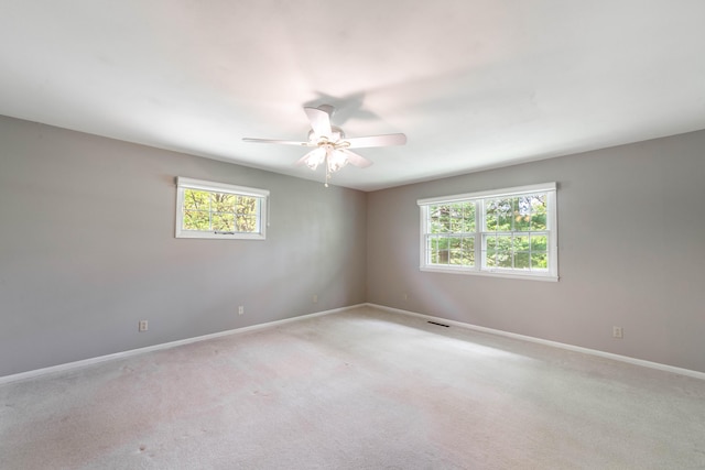 10155 E Union Church Rd, Centralia, MO 65240 - unfurnished room featuring healthy amount of natural light, baseboards, a ceiling fan, and light colored carpet
