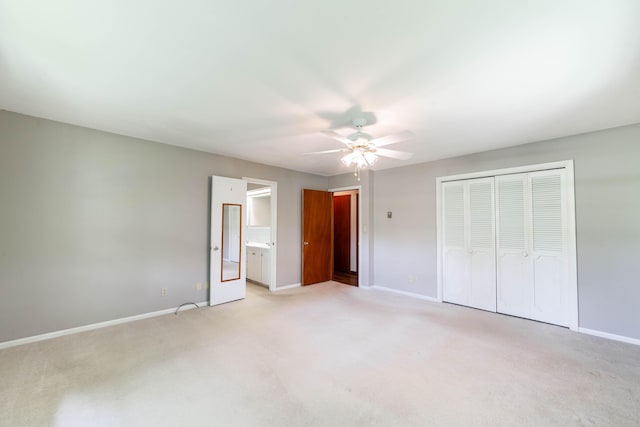 10155 E Union Church Rd, Centralia, MO 65240 - unfurnished bedroom featuring light colored carpet, baseboards, a closet, a ceiling fan, and connected bathroom