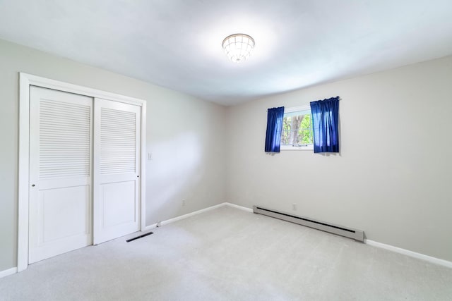 10155 E Union Church Rd, Centralia, MO 65240 - unfurnished bedroom with a baseboard heating unit, carpet flooring, baseboards, and a closet