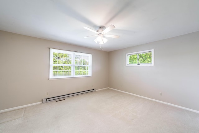 10155 E Union Church Rd, Centralia, MO 65240 - spare room featuring baseboard heating, light carpet, a ceiling fan, and baseboards
