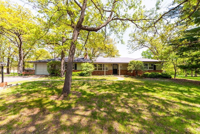 10155 E Union Church Rd, Centralia, MO 65240 - single story home featuring an attached garage, driveway, a front lawn, brick siding, and a chimney