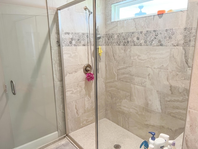 full bath with a shower stall