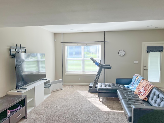 living area featuring carpet and baseboards
