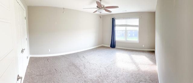 spare room with ceiling fan, baseboards, and carpet flooring